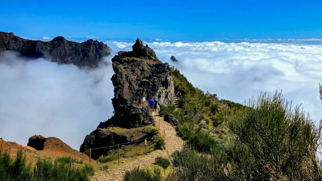 Trail leading out onto a cliff among the clouds