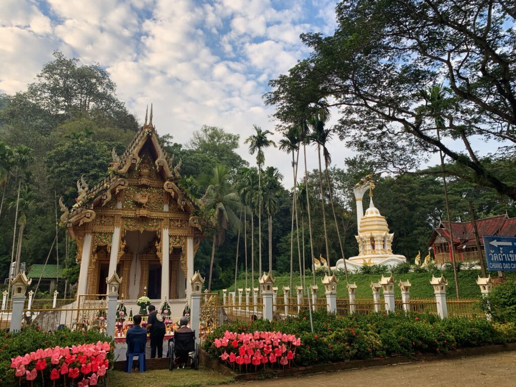 People praying at outdoor temple structure