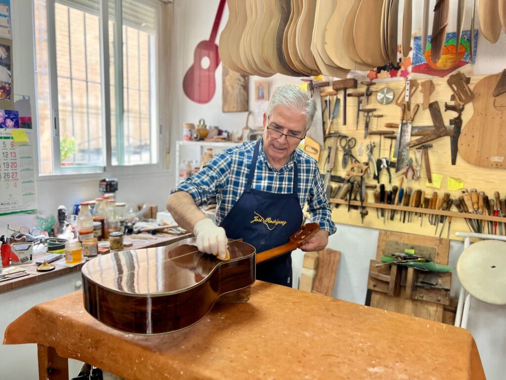 Man in workshop making guitars