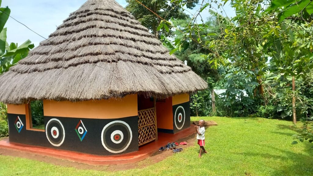 Thatched roof on a hut, surrounded by greenery