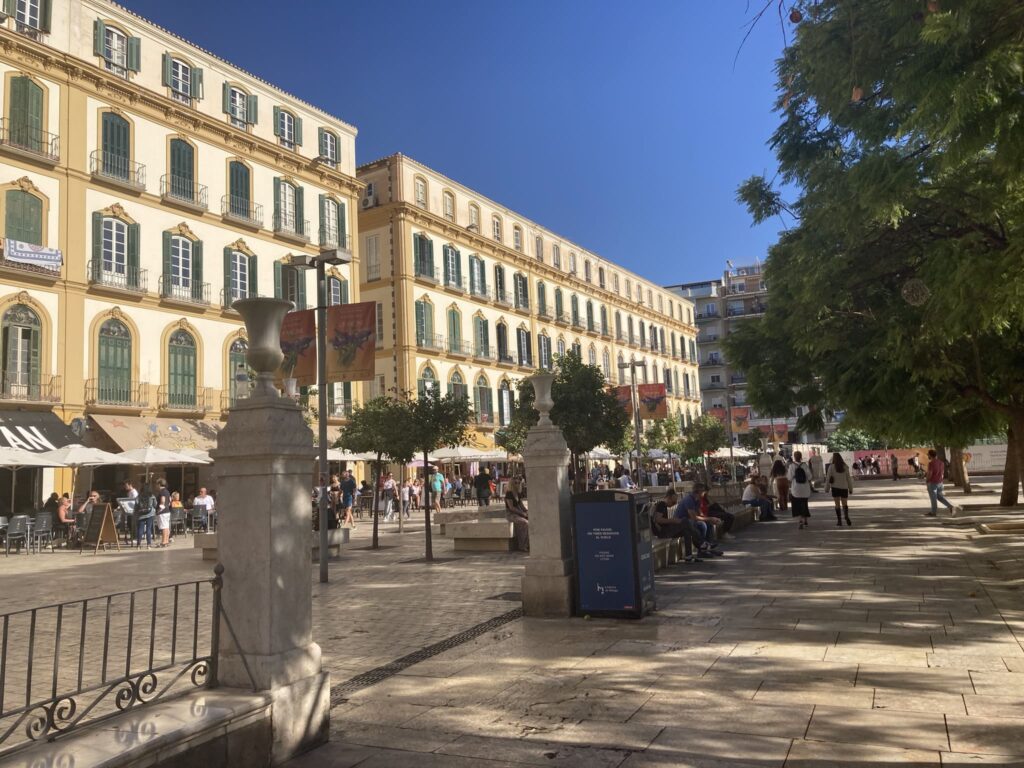 Square and pedestrian street flanked by ornate palace like building