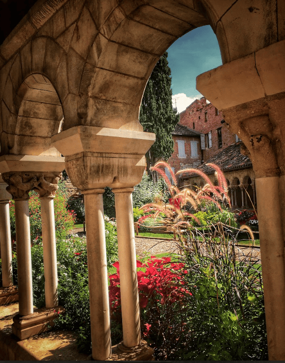 Arched wall near courtyard with flowers