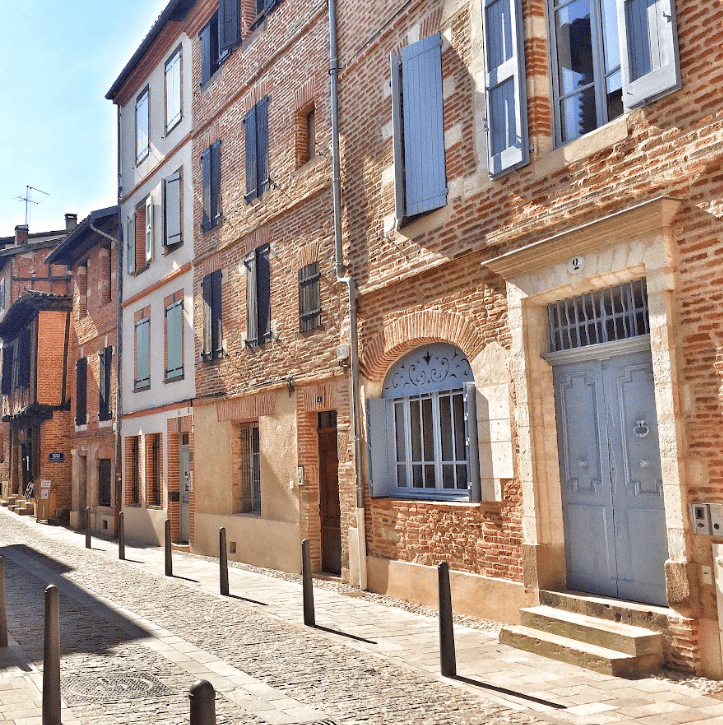 Brick facade of houses along a side street