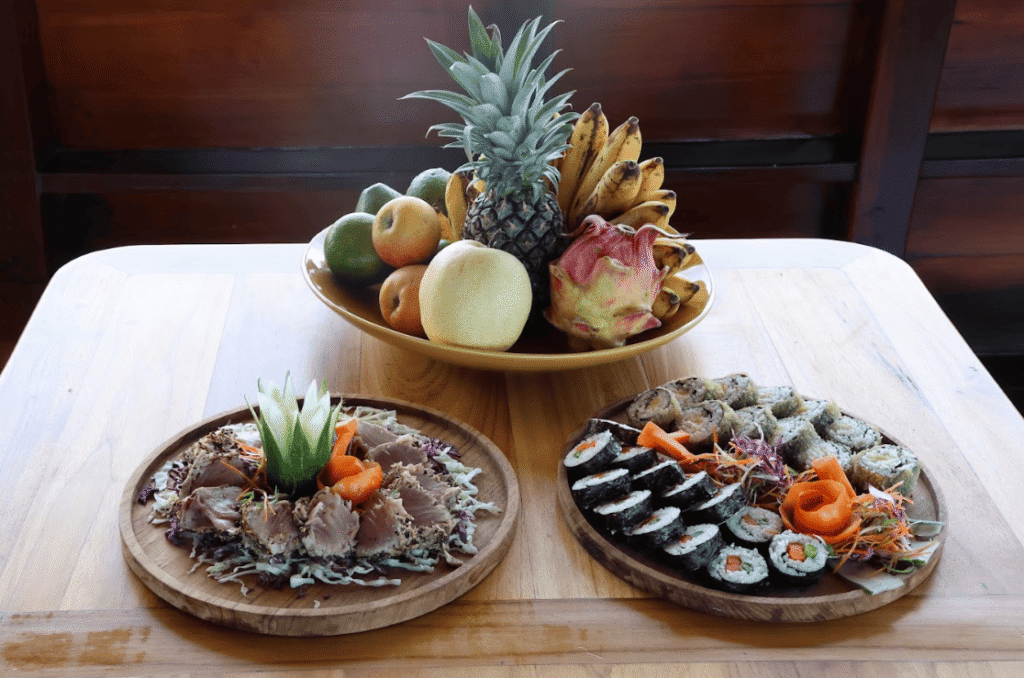 One bowl of fruit and two plats of seafood