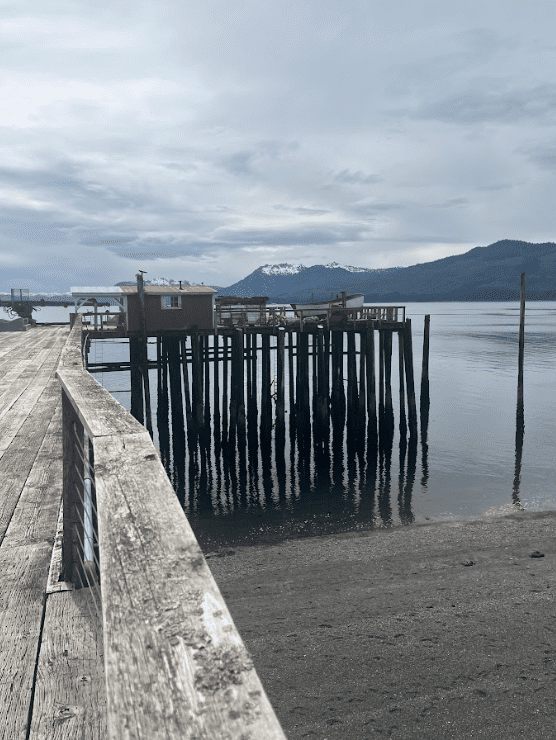 Pier with buildings in mountaineous landscape