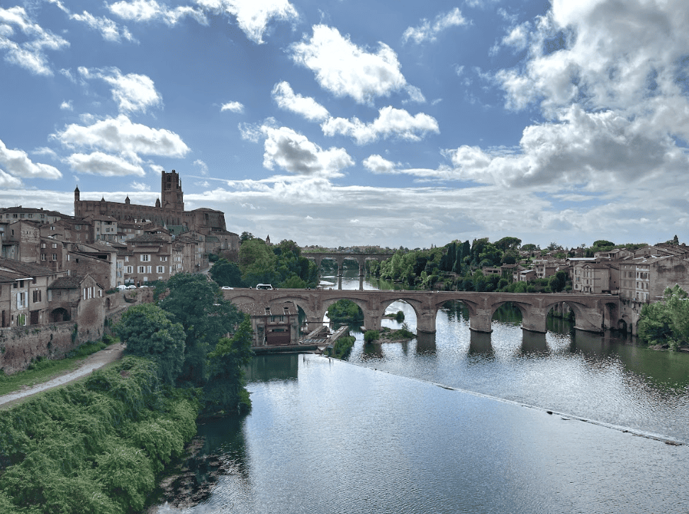 View of river and old arched stone bridge