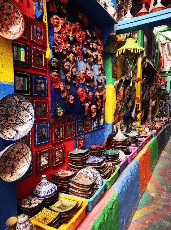 Colourful bazaar with goods displayed on walls and tables