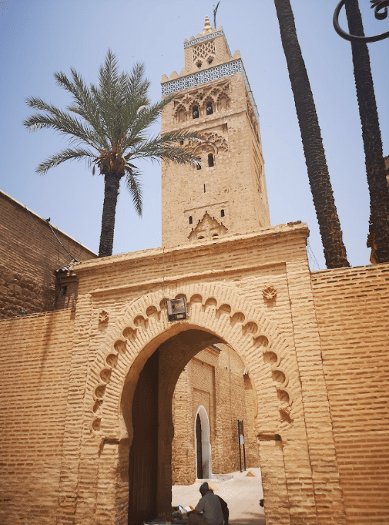 Tall minaret tower seen from street level