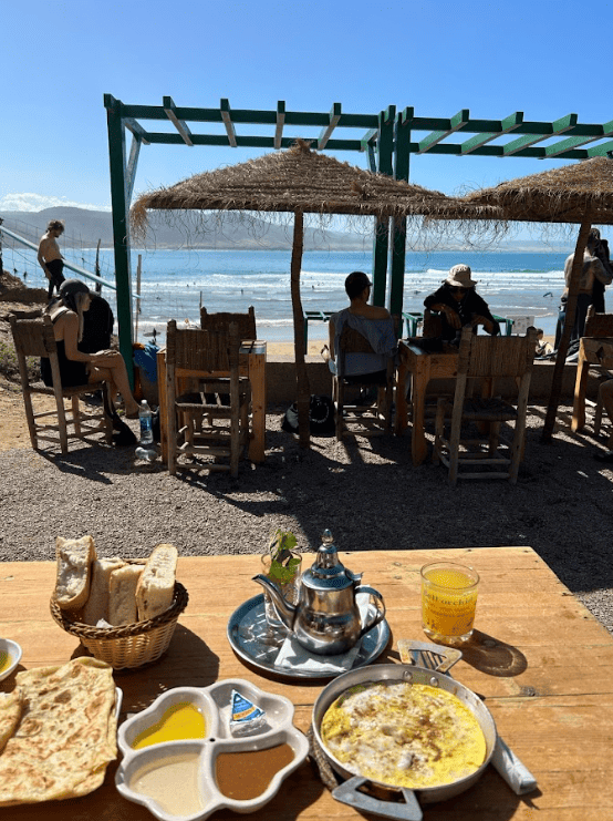 Table with several plates and dishes on the beach