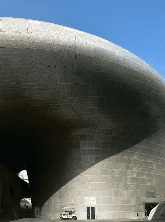 A chrome coloured building in oval shape