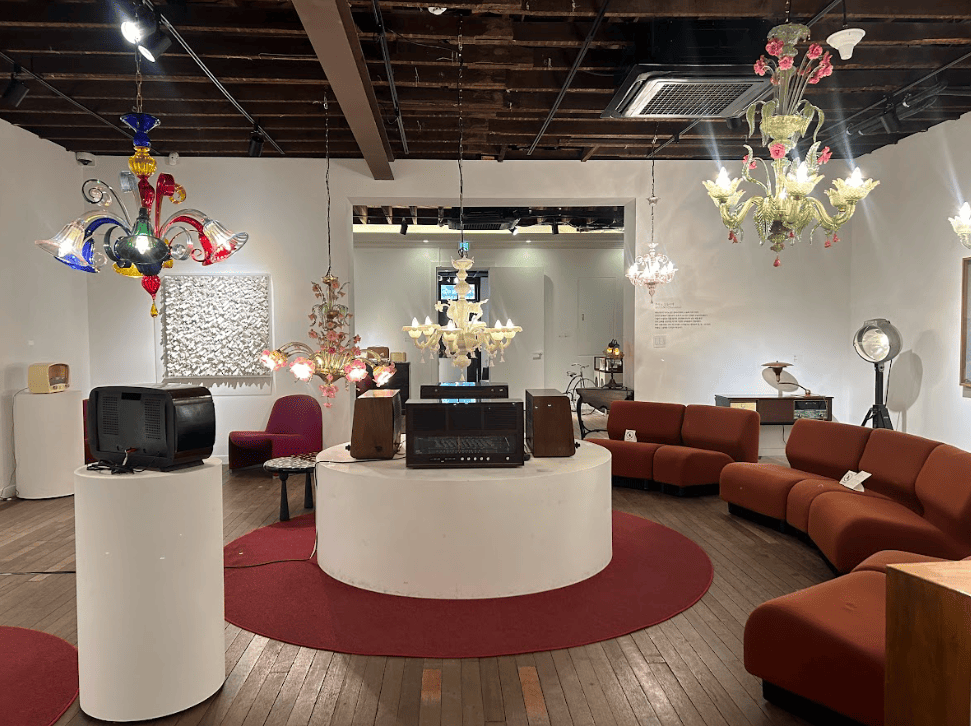 Lounge furniture inside an art gallery with colourful lamps