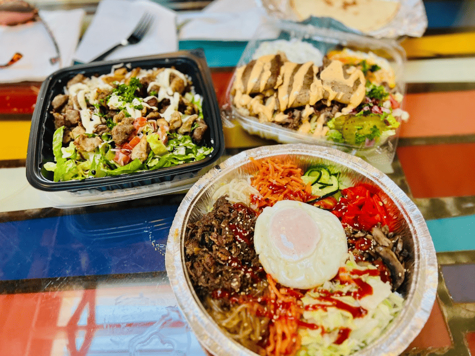 Three plates of colourful food on a colourful table