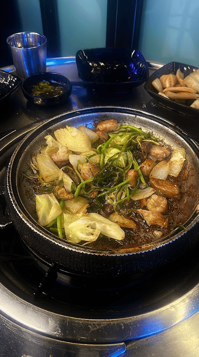 Bowl of food with broth on a table