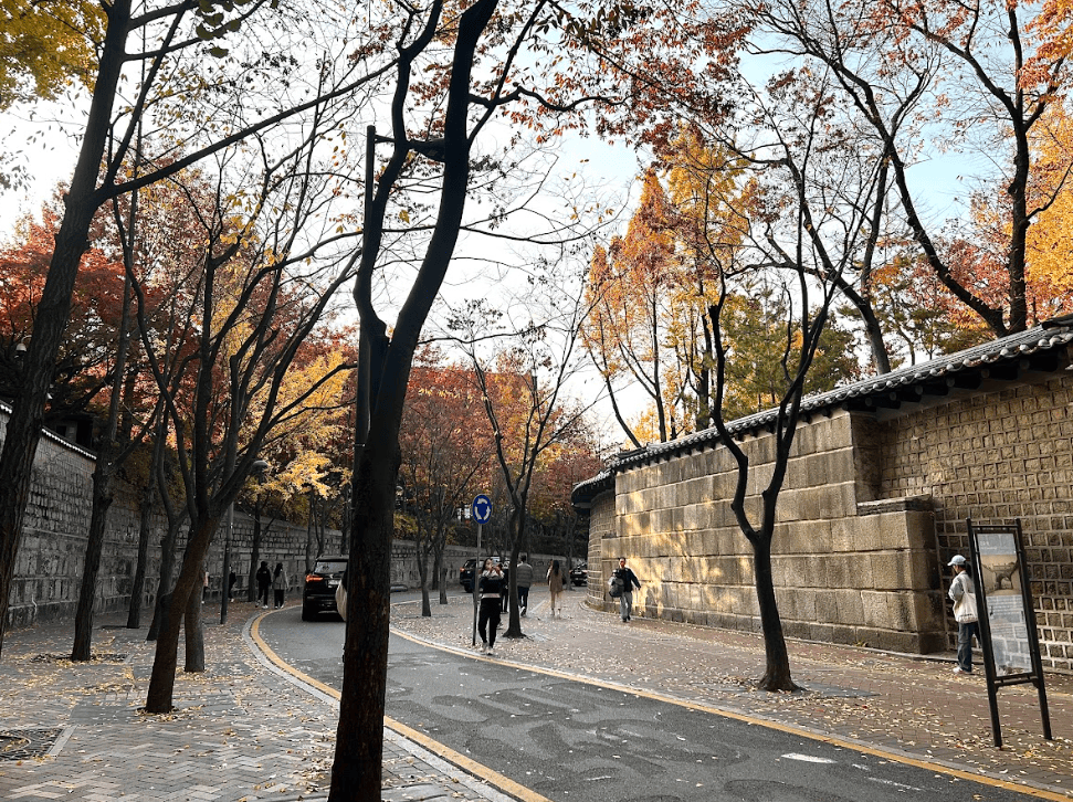 Pedestrian walkway in the middle of two stone walls.