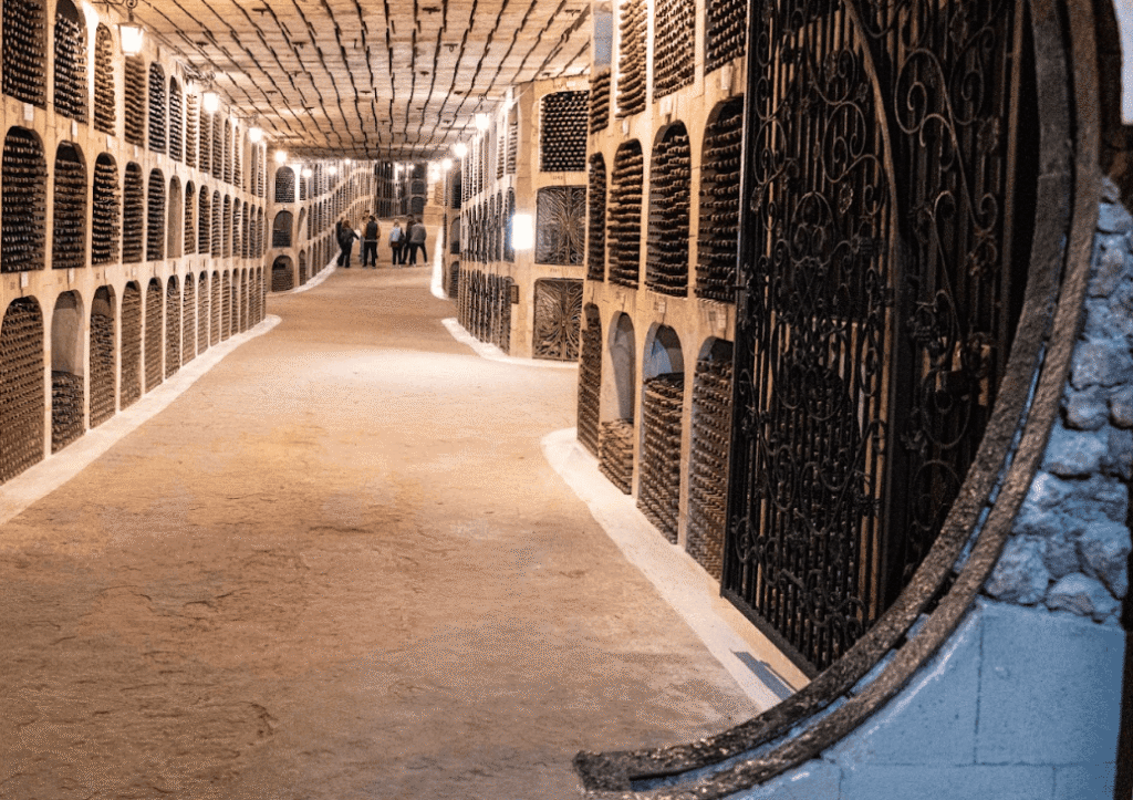 Underground wine cellar with people walking in the tunnels